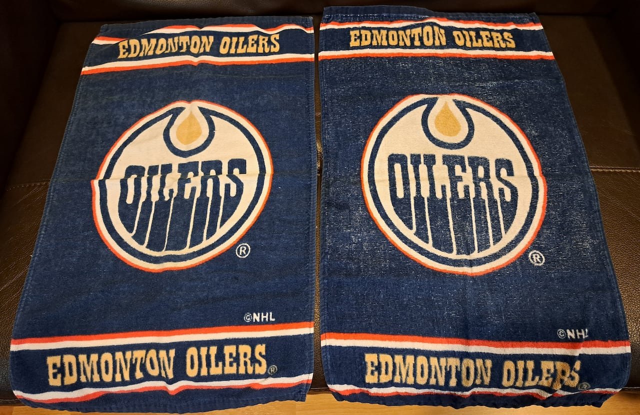 A pair of blue towels with a logo reading the word "Oilers" and additional text reading Edmonton Oilers.