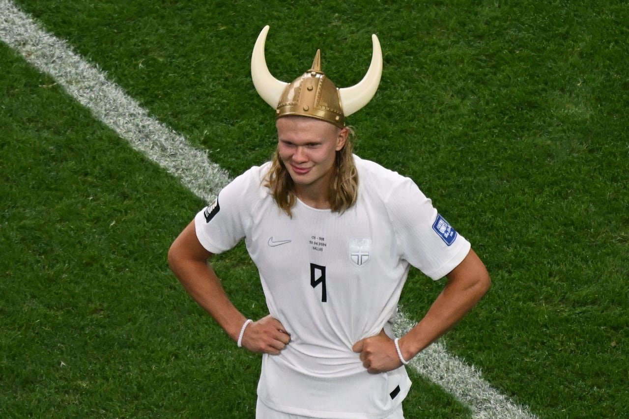 default-672 A man in a soccer jersey wearing a viking hat
